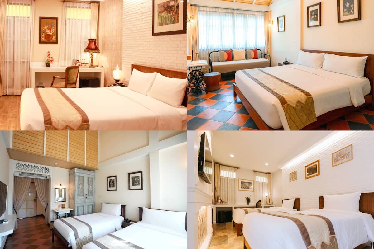 A hotel room with a bed, bedside table, lamp, and a view of the city.