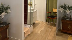 A modern bathroom with a glass shower enclosure, a white sink, and a vanity. - Exterior, balconies, terrace, 2 bathrooms, wifi, next to subway and train. (Madrid)