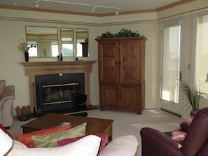 A living room with a fireplace, a large wooden cabinet, and a sofa. - You deserve it all! Awesome Views, Comfy Condo & Elevator! (Wintergreen Resort)