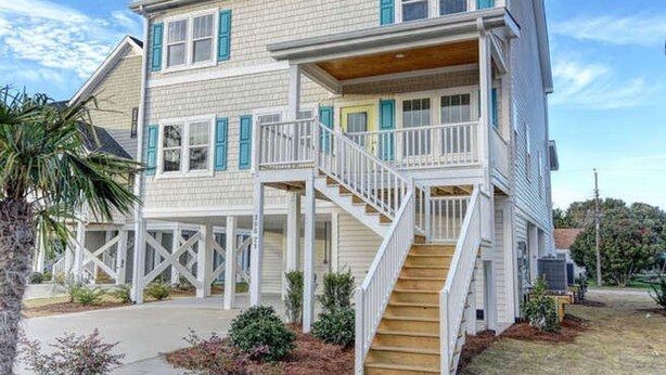 A two-story house with a balcony and a staircase leading to the second floor. - Newer home 2 blocks from downtown Carolina Beach (Carolina Beach)