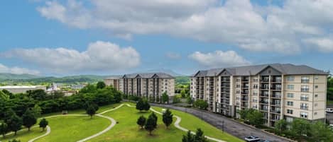 A residential complex with multiple apartment buildings, green lawns, and pathways.