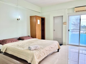 A bedroom with a bed, a wardrobe, a sliding glass door, and a ceiling-mounted air conditioning unit. - Sunshine Place Udon (Udon Thani)