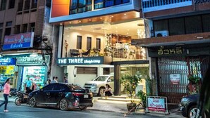 A multi-story hotel with balconies, a ground-level restaurant, and a sign in a foreign language. - The Three Hat Yai (Hat Yai)