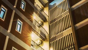 A multi-story building with balconies, air conditioning units, and a modern architectural design. - The Terrace Khlongtoei (Hat Yai)