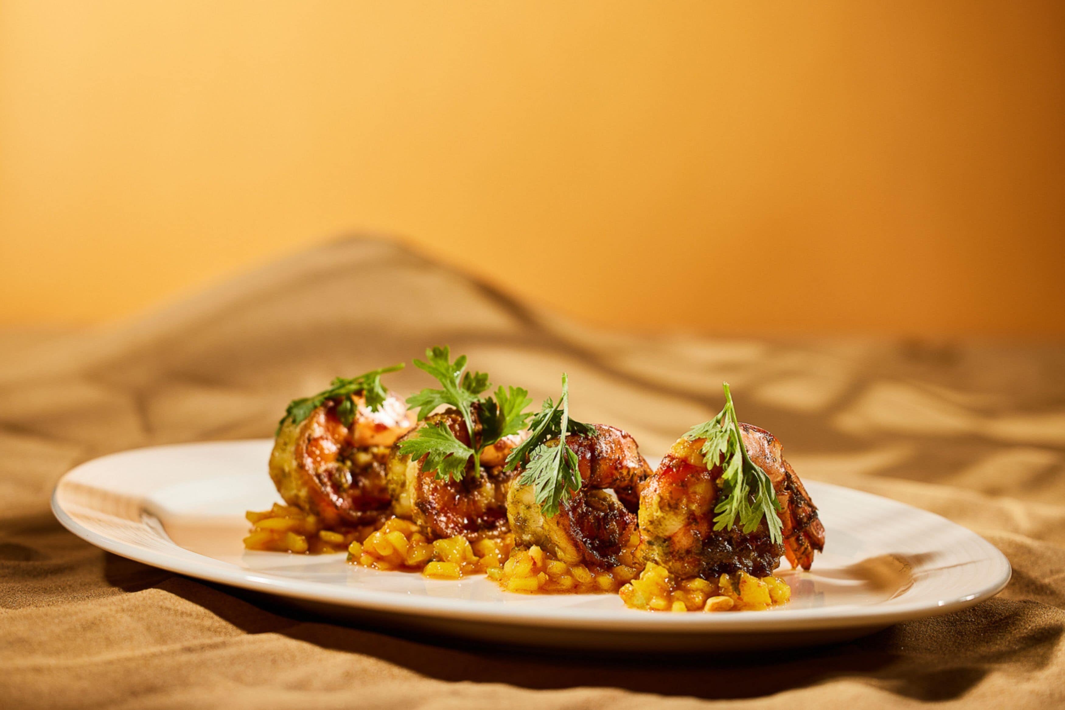 A plate of food with a white plate on a tablecloth.