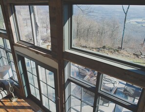 Enjoy expansive mountain views from the large windows, framed by rustic wooden beams.