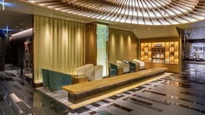 A modern lobby with a central seating area, a reception desk, and a unique ceiling design. - Hotel Metropolitan Akita (Akita)