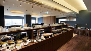 A buffet setup with various food items and utensils. - Hotel Metropolitan Akita (Akita)