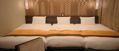 A hotel room with a large bed, two bedside tables, a chair, and a headboard with a chevron pattern.