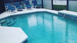A swimming pool with a tiled edge, a white deck, and several lounge chairs. - WOW! Championsgate-Minutes to disney,private pool,wifi ,tennis,gym,games room  (Davenport)