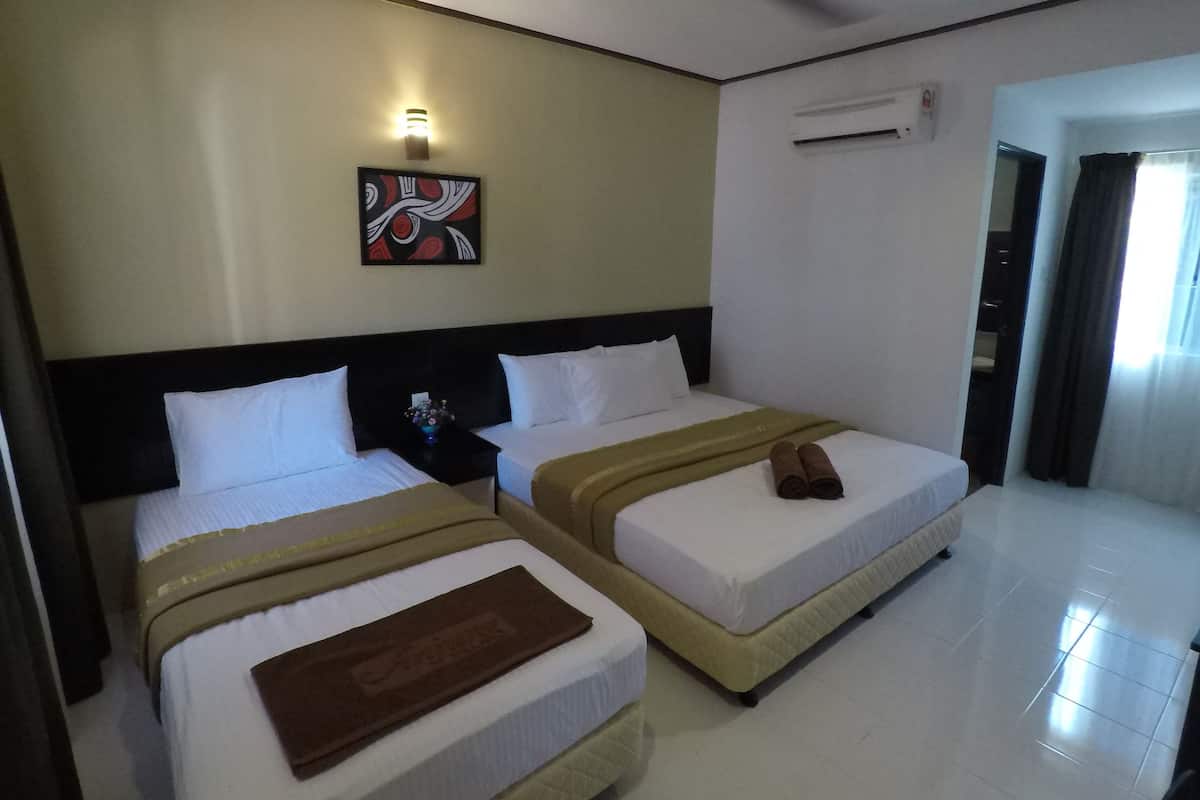 A hotel room with two beds, a ceiling fan, an air conditioning unit, and a painting on the wall.