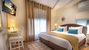 A neatly arranged bedroom with a bed, bedside tables, a chair, and a TV mounted on the wall. - Mike's House Jerusalem (Jerusalem)
