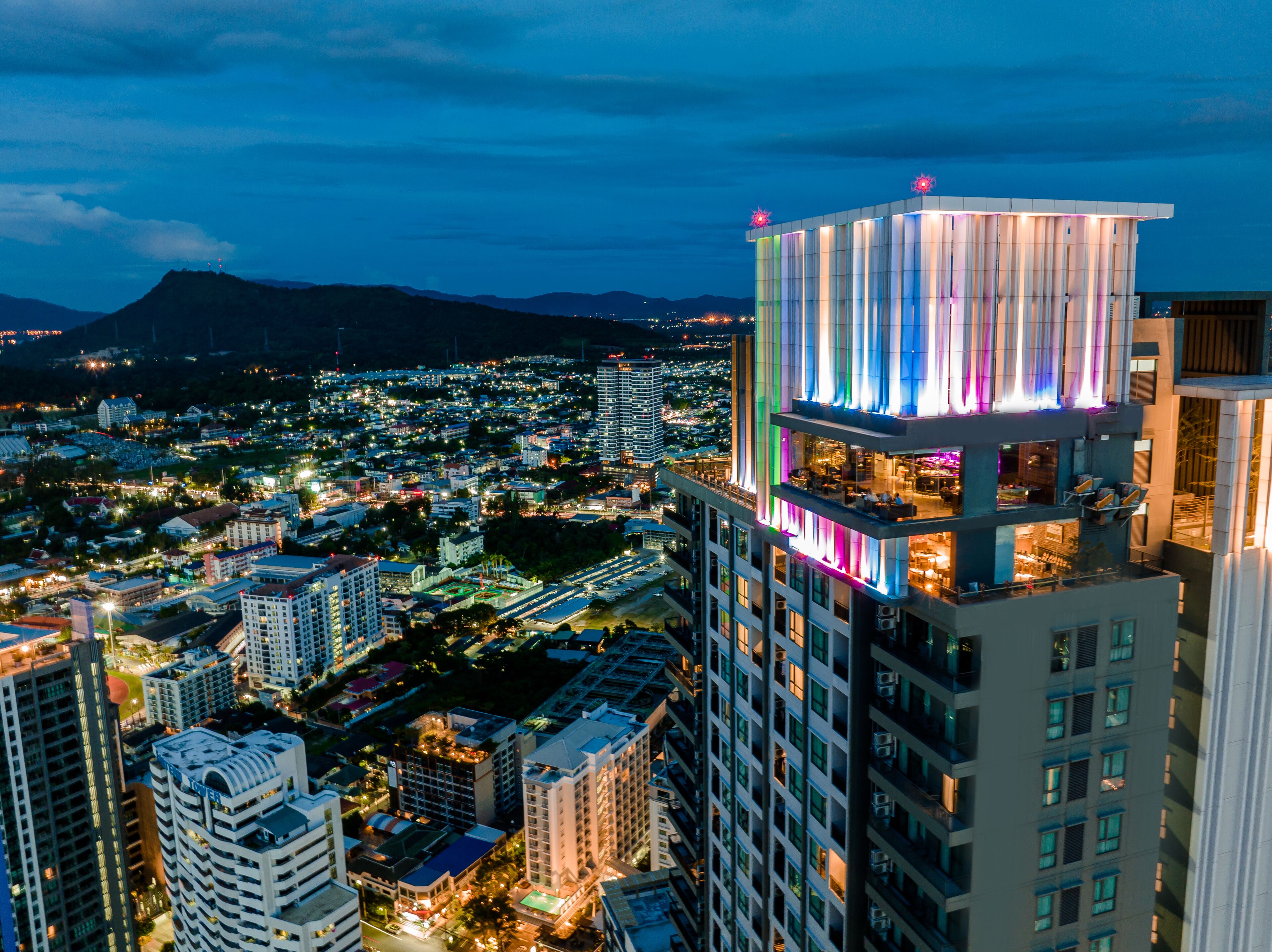 A high-rise hotel with multiple floors, balconies, and a modern architectural design.