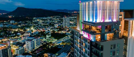 A high-rise hotel with multiple floors, balconies, and a modern architectural design.