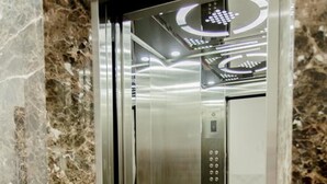 An elevator with a metallic interior and a control panel. - Phu Hong Hotel (Phu Quoc)