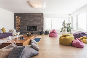 Exclusive Villa, 4 Bedrooms, Sauna, Mountainside | Living area | Flat-screen TV, fireplace - Glücksthaler (Aich)