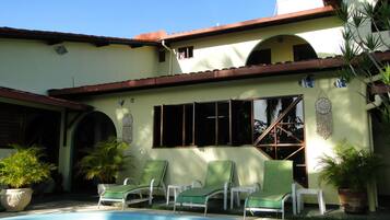 Relax by the pool surrounded by lounge chairs and enjoy the covered patio with additional seating.