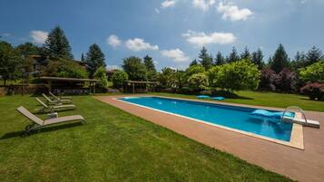 Seasonal outdoor pool, pool loungers