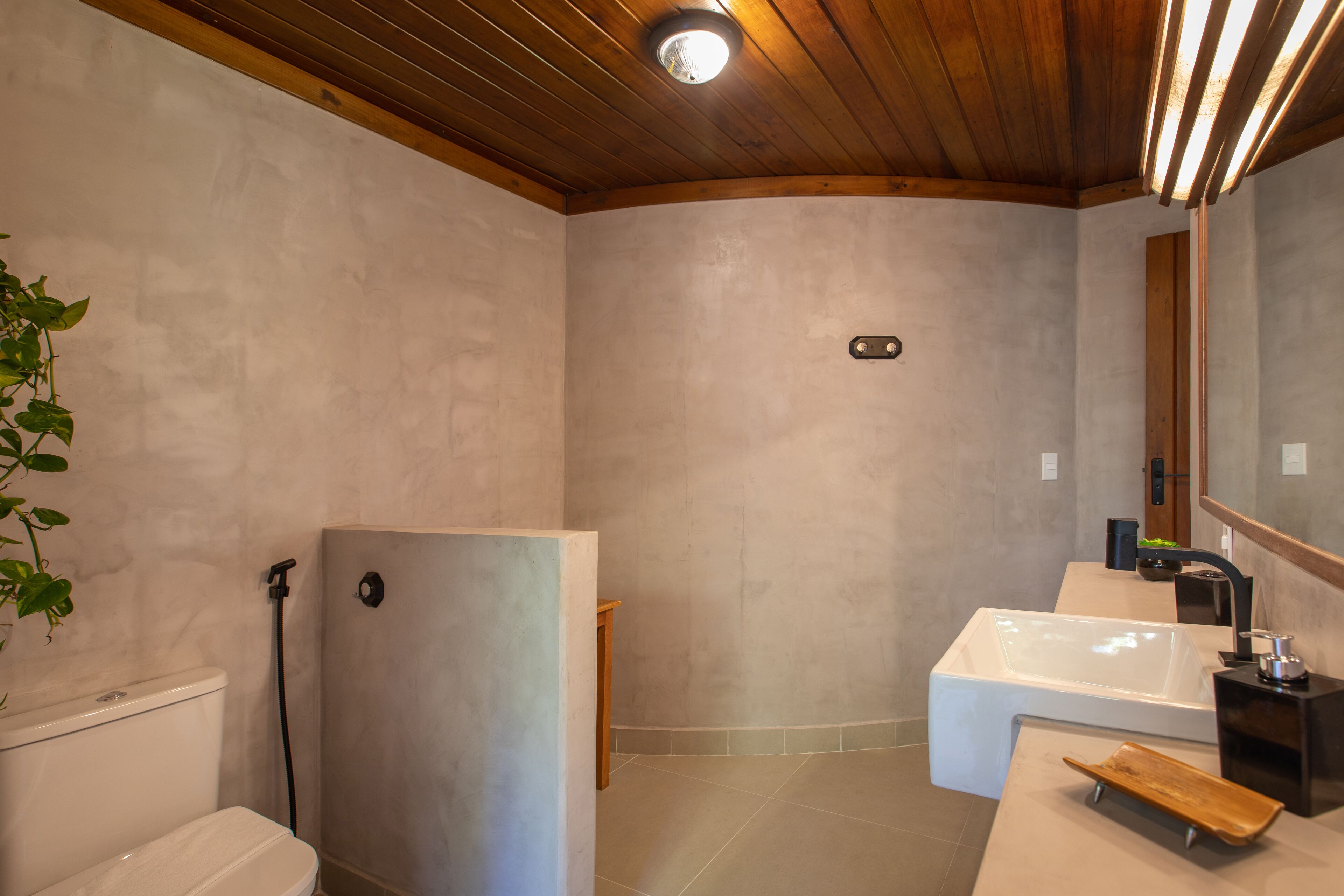 A bathroom with a shower, toilet, and bathtub.