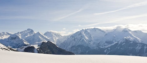 A snow-covered mountain landscape with clear skies.