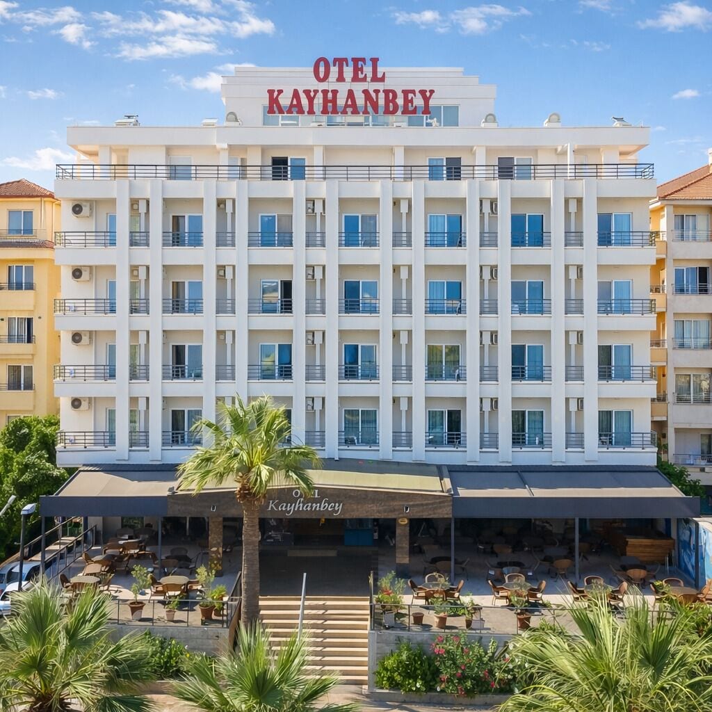 A multi-story hotel with balconies and a covered outdoor seating area.