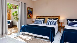 A bedroom with two beds, a ceiling fan, and a large window with curtains. - Pousada Rio Claro (Pocone)