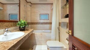 A bathroom with a bathtub, a shower, a sink, and a toilet.