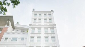 A multi-story hotel with a central entrance, a visible sign for the 'CENTRAL HOTEL,' and a 'VIEW HOTEL' sign on the left.