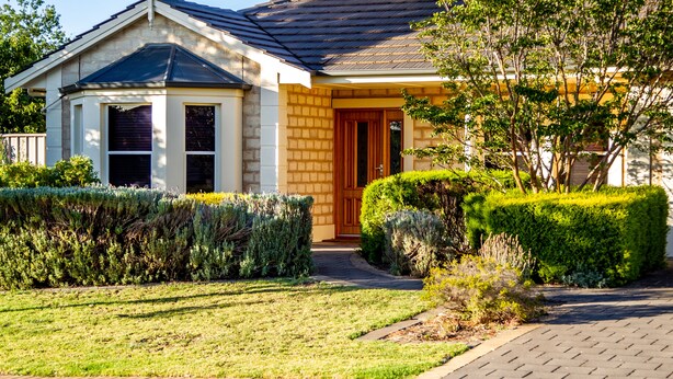 A two-story house with a brick facade, a dark roof, and a front door with a wooden door frame. - Lochnagar Barossa - Adults Only (Tanunda)