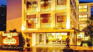 A multi-story hotel with a modern design, featuring balconies and a well-lit entrance. - 9 Suite Luxury Boutique Hotel (Chiang Mai)