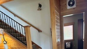 A wooden staircase with a handrail, carpeted steps, and a wooden floor. - McKenzie Riverfront-w Hottub woodstove+wood (Vida)