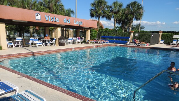 A swimming pool with lounge chairs and a covered seating area labeled "Vista del Lago". - Holiday home winter / summer (Winter Garden)