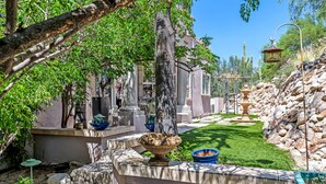 A courtyard with a fountain, stone steps, and a well-maintained lawn. - Tucson Hilltop Estate: Sleeps 9, Heated Pool  & Spa, Game Room, Cantina, Gas BBQ (Tucson)