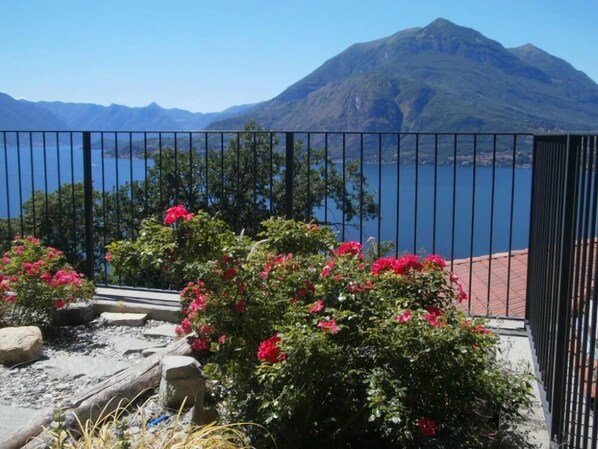 A balcony with a view of a lake and mountains.