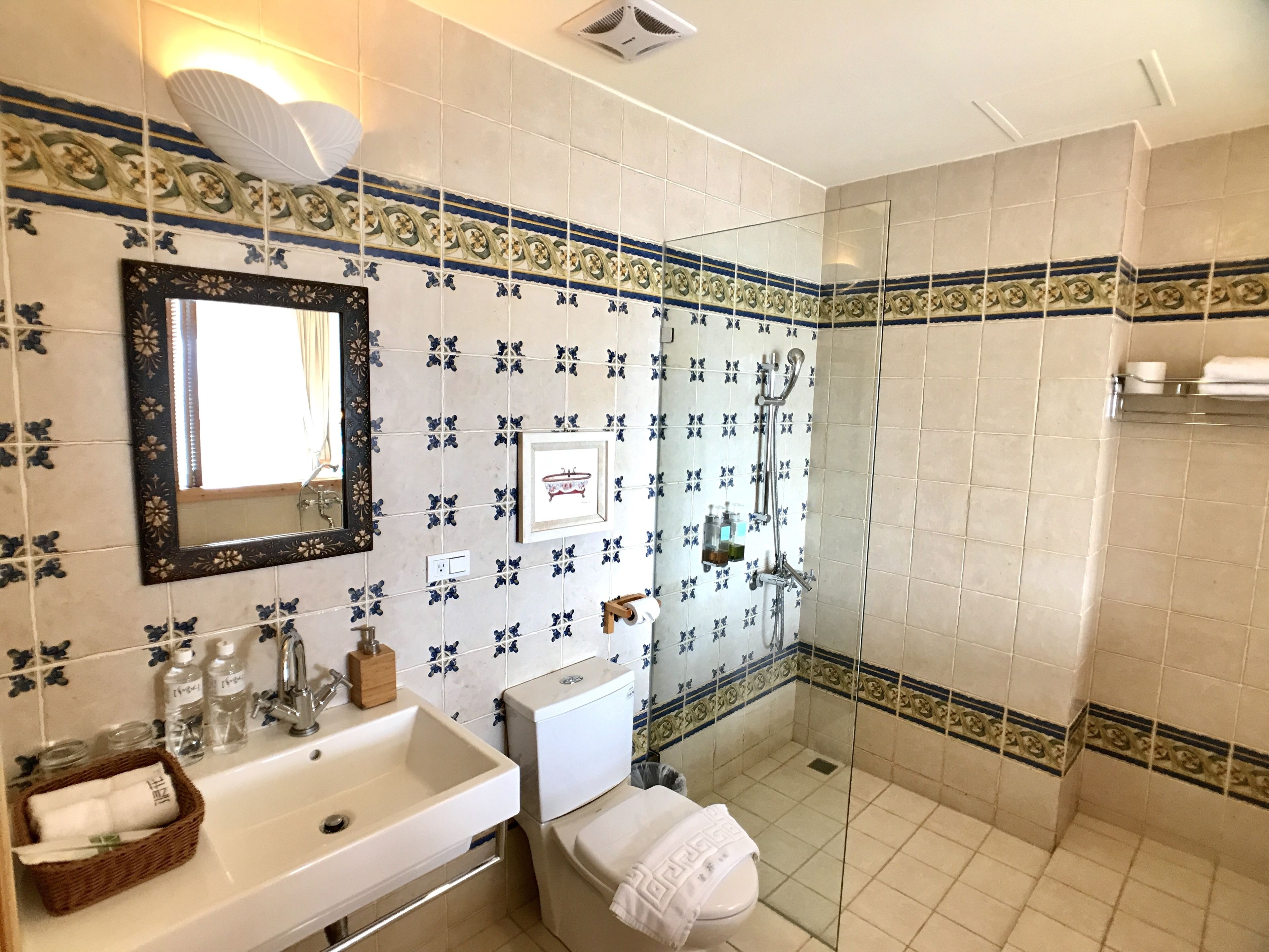 A bathroom with a sink, toilet, and shower.