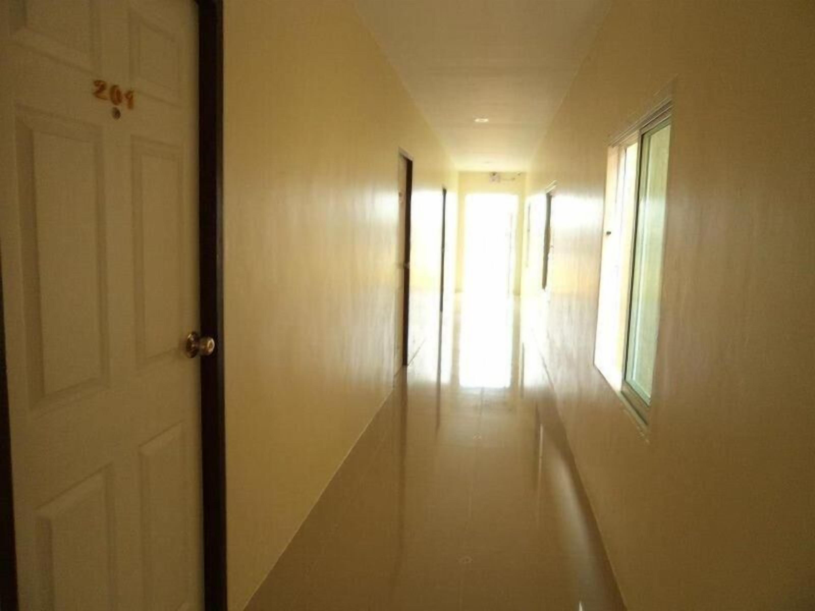 A corridor with a door labeled '201' and a window on the right.
