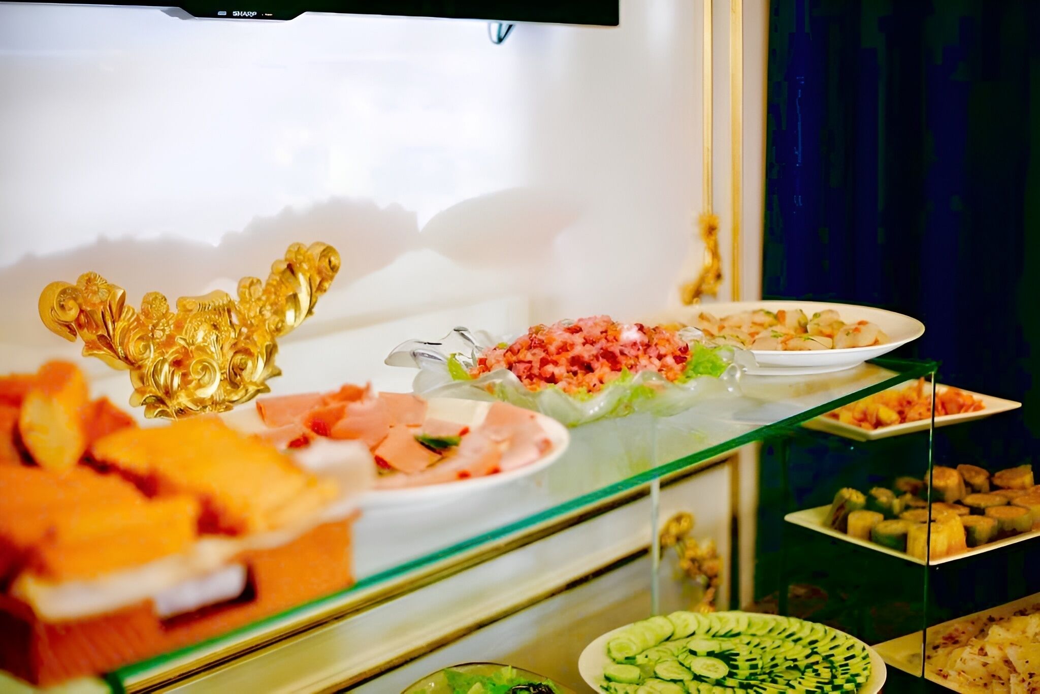 A buffet with various food items including fruits, vegetables, and prepared dishes.