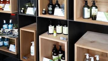 A display of various skincare products on wooden shelves.
