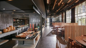 A modern restaurant with a long counter, wooden tables, and a high ceiling with exposed beams. - Orient Luxury Hotel (Chiayi City)