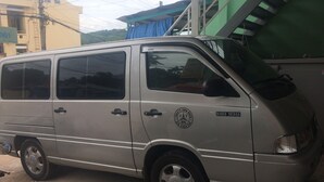 A silver van parked on a street. - Y Thu Guesthouse (Phu Quoc)