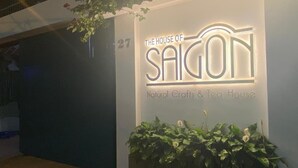 A sign for "The House of Saigon" with a neon sign and a number "27" above it.