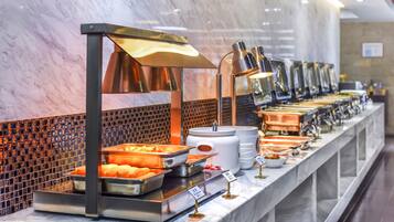 A buffet setup with various food items and a marble counter.