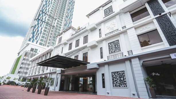 A hotel with a modern facade, large windows, and a prominent entrance with a covered walkway. - Grand Belllo Hotel JBCC (Johor Bahru)