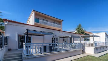 Relax on the shaded balcony overlooking the well-maintained lawn.