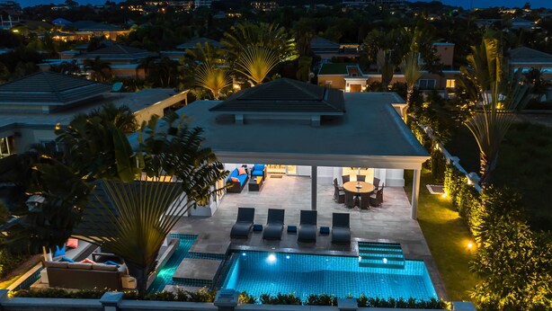 A residential property with a swimming pool, outdoor seating, and a covered patio area. - Luxury Pool Villa 608 (Pattaya)