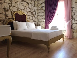 Relax in a serene bedroom with a comfortable bed, nightstand, and dresser.
