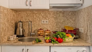 Apartment | Private kitchenette | Fridge, stovetop, electric kettle, cookware/dishes/utensils