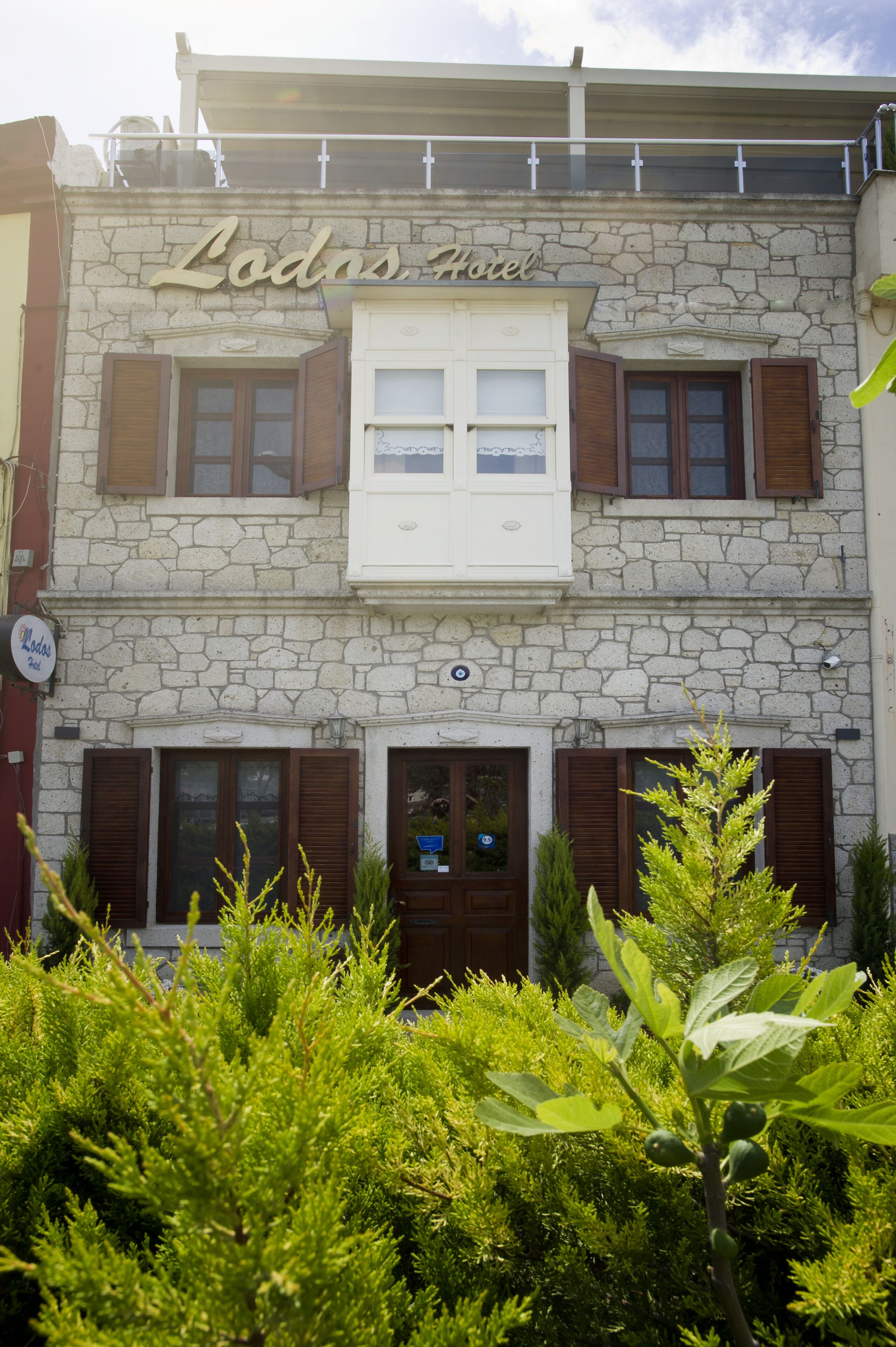 A two-story stone building with the sign "Lodins Hotel" above the entrance.