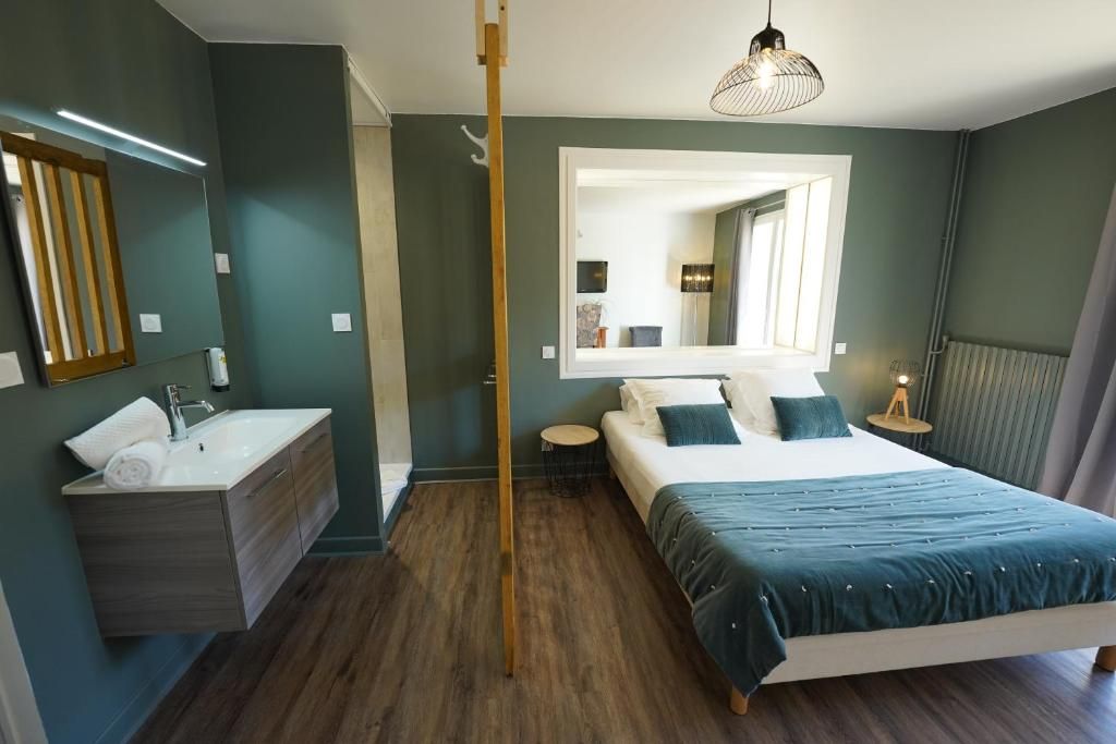 A bedroom with a bed, bedside table, and a mirror.
