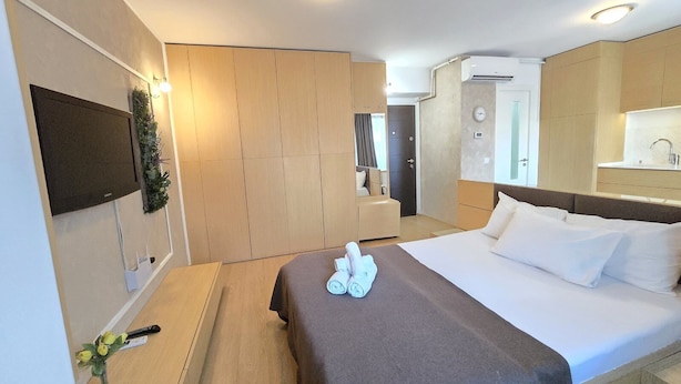 Une chambre d’hôtel avec un lit, une télévision, un bureau et une salle de bain.